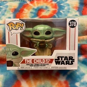 Never opened funko POP child with cup